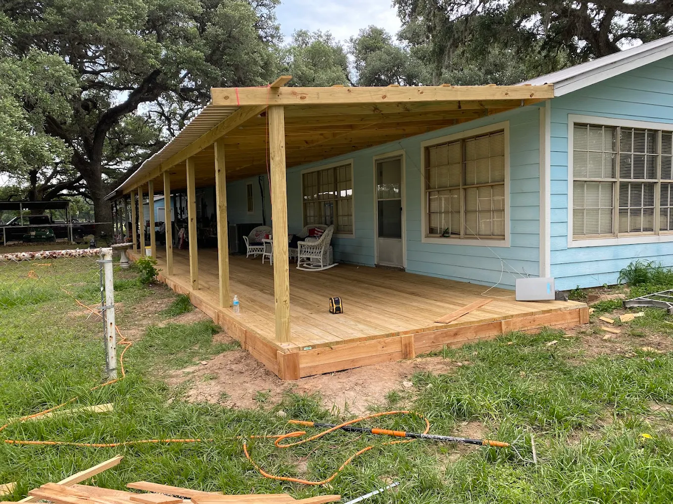 Texas backyard with a custom cedar privacy fence and wood deck built by Old School Construction